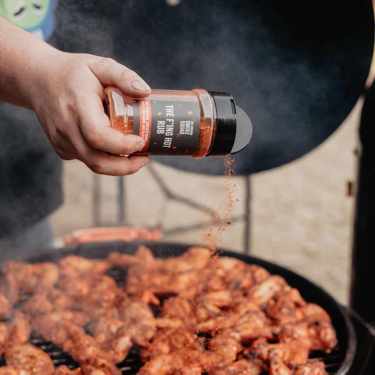 scotch bonnet rub being sprinkled over chicken wings