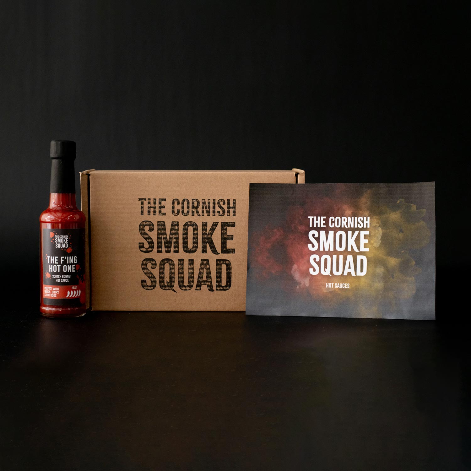 F'ing hot scotch bonnet hot sauce stood next to the cornish smoke squad giftbox
