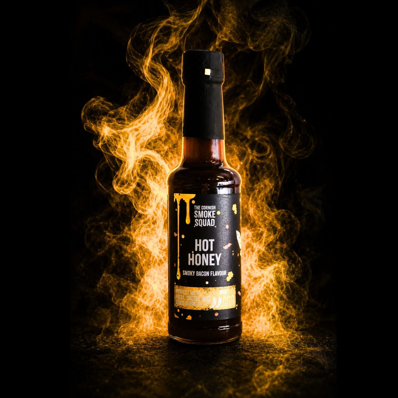 Bottle of Hot Honey with flames on a black background