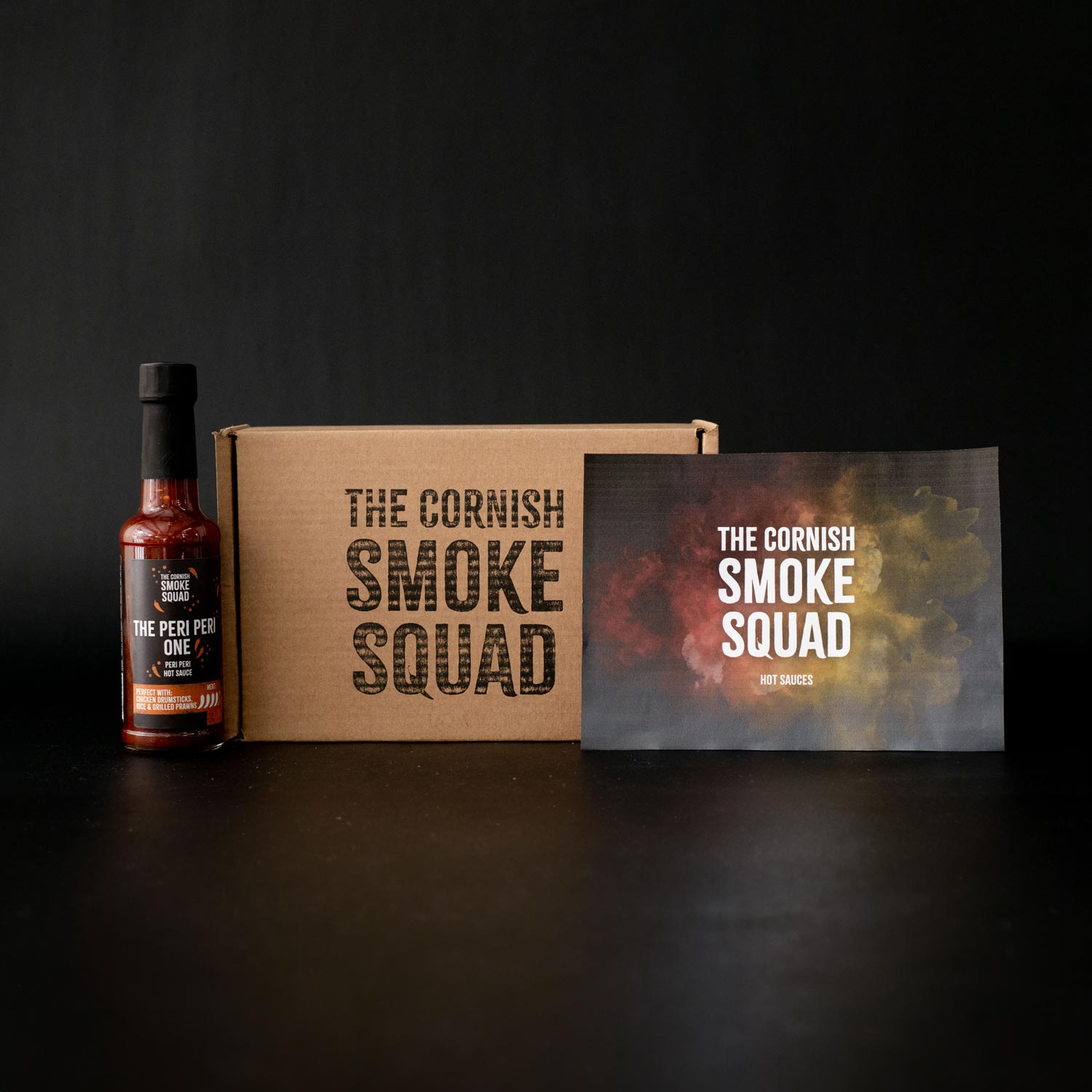 Peri Peri hot sauce next to cornish smoke squad giftbox
