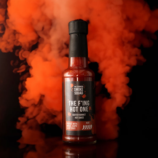 Scotch bonnet hot sauce surrounded by red smoke