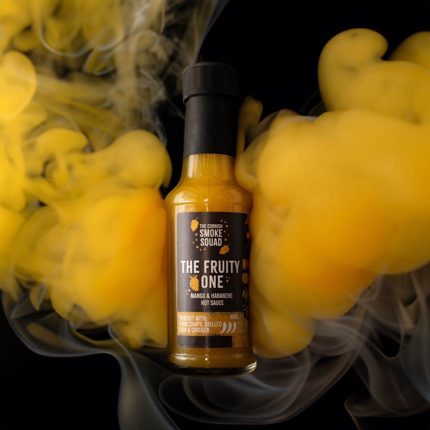 Mango & Habanero hot sauce surrounded by yellow smoke
