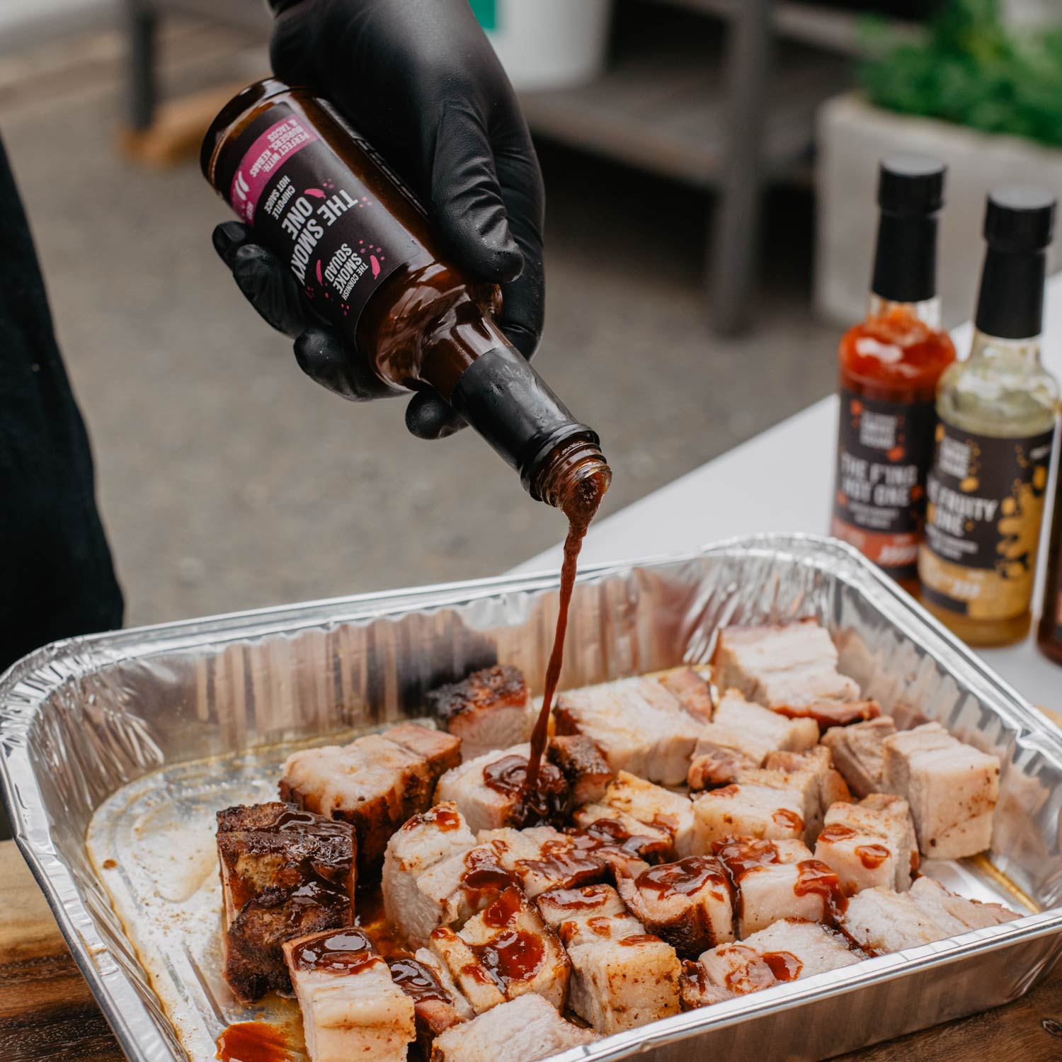 Chipotle hot sauce is poured over BBQ'd pork